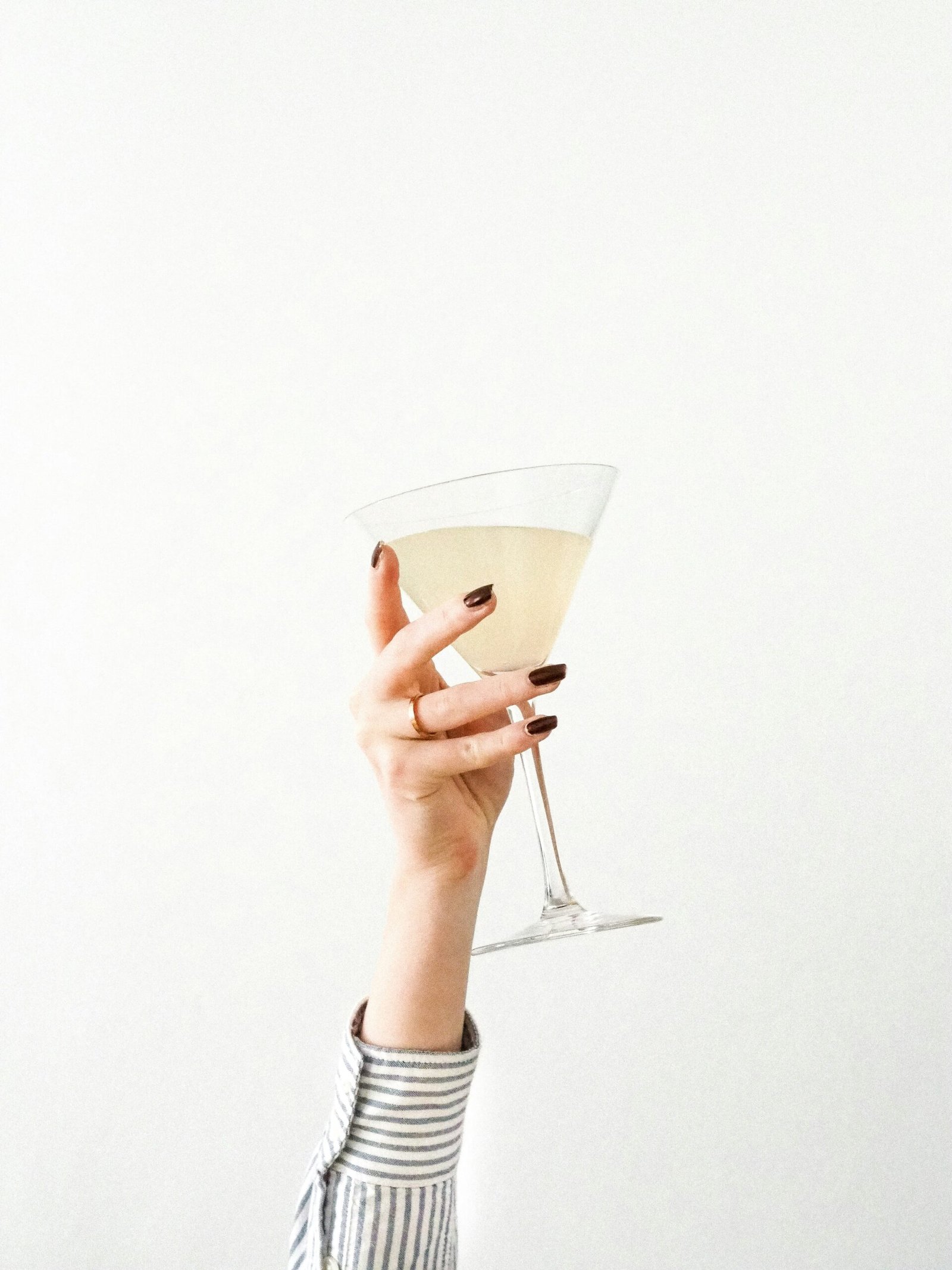 person holding clear drinking glass